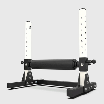 Black and white exercise equipment with measurement scales on a light gray background