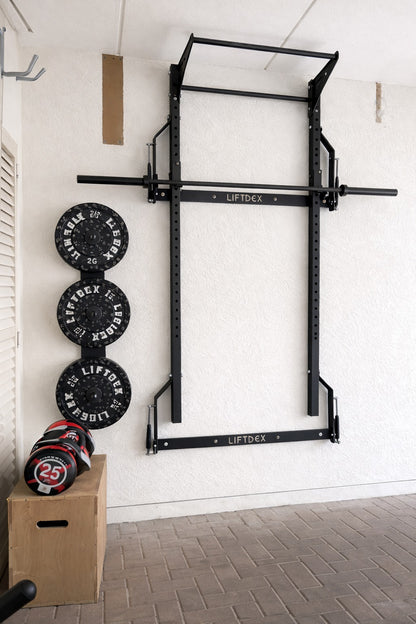 Wall-mounted pull-up bar with weight plates and a box in a home gym setting.