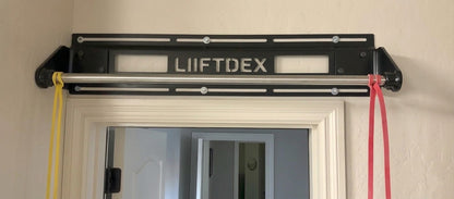 LIIFTDEX pull-up bar mounted on a door frame with resistance bands attached.
